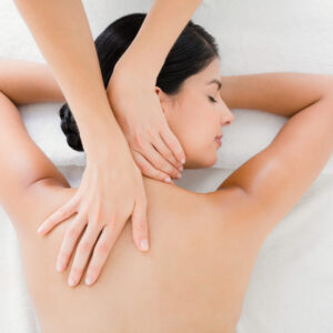Upward view of woman receiving back massage at spa center